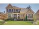 Charming two-story brick home with a well-manicured lawn and inviting front porch at 17809 Pawleys Plantation Ln, Charlotte, NC 28278