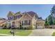 Beautiful two-story brick home featuring an attached two-car garage and manicured lawn at 17809 Pawleys Plantation Ln, Charlotte, NC 28278