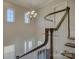 Grand foyer showcasing a chandelier, staircase with dark wood handrail, and transom windows at 17809 Pawleys Plantation Ln, Charlotte, NC 28278