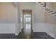 Spacious foyer showcasing hardwood floors, wainscoting, and an open staircase at 17809 Pawleys Plantation Ln, Charlotte, NC 28278