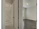 Hallway leading to a bedroom with tile floors and a view of the interior of the home at 17809 Pawleys Plantation Ln, Charlotte, NC 28278