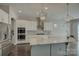 Modern kitchen with stainless steel appliances, white cabinets, and a center island with granite countertop at 17809 Pawleys Plantation Ln, Charlotte, NC 28278