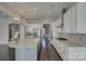 Open kitchen featuring stainless steel appliances, granite counters, white cabinets, and hardwood floors at 17809 Pawleys Plantation Ln, Charlotte, NC 28278