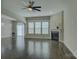 Open concept living room with large windows, hardwood floors, fireplace and ceiling fan at 17809 Pawleys Plantation Ln, Charlotte, NC 28278