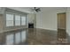 Spacious living room with dark hardwood floors, a ceiling fan, and a fireplace at 17809 Pawleys Plantation Ln, Charlotte, NC 28278