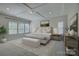 Spacious main bedroom with a tray ceiling, large windows, and a seating area at 17809 Pawleys Plantation Ln, Charlotte, NC 28278