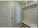 Bright mudroom with white storage bench, coat hooks and shelving, perfect for organization at 17809 Pawleys Plantation Ln, Charlotte, NC 28278