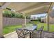 A covered patio area featuring a table, chairs and a view of the beautiful green grass at 17809 Pawleys Plantation Ln, Charlotte, NC 28278