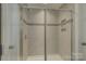 Modern shower with glass doors, tiled walls, and built-in shelves at 17809 Pawleys Plantation Ln, Charlotte, NC 28278