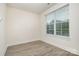 Bright bedroom with light wood flooring, a large window, and neutral-colored walls at 2021 Summey Ave, Charlotte, NC 28205