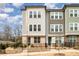 Charming townhome with mixed siding, brick accents, black fence and professional landscaping in a walkable community at 2021 Summey Ave, Charlotte, NC 28205