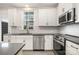 Modern kitchen with stainless appliances, quartz countertops, and stylish white subway tile backsplash at 2021 Summey Ave, Charlotte, NC 28205