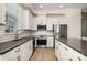 Modern kitchen featuring stainless steel appliances, white cabinets, and a subway tile backsplash at 2021 Summey Ave, Charlotte, NC 28205