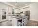 Chef's kitchen features stainless appliances, an island with seating, and a door leading outside at 2021 Summey Ave, Charlotte, NC 28205