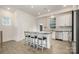 Modern kitchen with stainless steel appliances, a kitchen island with seating, and luxury vinyl flooring at 2021 Summey Ave, Charlotte, NC 28205