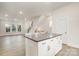 Bright living room with luxury vinyl flooring open to kitchen with island and staircase at 2021 Summey Ave, Charlotte, NC 28205