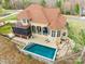 Aerial view of a home with a private backyard oasis, including a pool, patio, and outdoor living spaces at 2036 Rocky Stream Rd, York, SC 29745