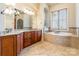 Relaxing bathroom featuring a soaking tub with mosaic surround, a double vanity, and tiled floors at 2036 Rocky Stream Rd, York, SC 29745