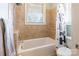 Bright bathroom with a tub and shower combination, featuring tiled walls and a window for natural light at 2036 Rocky Stream Rd, York, SC 29745