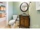 Charming powder room with beautiful vanity, complimented by painted green walls and tile flooring at 2036 Rocky Stream Rd, York, SC 29745