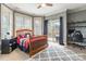 Well-lit bedroom with carpeted floor, bay windows, and access to the outdoor balcony at 2036 Rocky Stream Rd, York, SC 29745