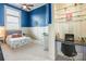 Bright bedroom with blue accent wall, carpeted floors, wainscoting, and a built-in desk at 2036 Rocky Stream Rd, York, SC 29745