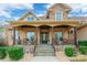 Inviting covered front porch with stone stairs, stylish railings, and comfortable seating area at 2036 Rocky Stream Rd, York, SC 29745