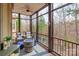 Screened in porch with comfortable seating and a firepit, overlooking the woods and pool at 2036 Rocky Stream Rd, York, SC 29745