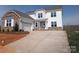 Charming two-story home with stone accents, attached garage, and concrete driveway at 2057 Fordhill St, Rock Hill, SC 29732