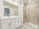 Modern bathroom featuring a double sink vanity, framed mirror, and glass enclosed shower with tiled surround at 2080 Old Rivers Rd, Concord, NC 28027