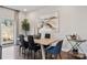 Bright dining room with light wood table, modern art, hardwood floors, and sliding door at 2080 Old Rivers Rd, Concord, NC 28027