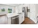 Kitchen island featuring stainless steel appliances, hardwood floors, and a backyard view at 2080 Old Rivers Rd, Concord, NC 28027