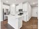 Modern kitchen featuring stainless steel appliances, a large island, and hardwood floors at 2080 Old Rivers Rd, Concord, NC 28027