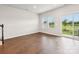 Open-concept living room features wood floors, a staircase, and a sliding glass door at 2080 Old Rivers Rd, Concord, NC 28027