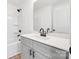 A clean bathroom features gray cabinets, white counters, a mirror and shower-tub combo at 211 E Rice St, Landis, NC 28088