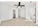 Bedroom with a view to a bathroom and walk-in closet, neutral carpet and white walls at 211 E Rice St, Landis, NC 28088