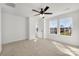 Sunlit bedroom with neutral carpet, white walls, ceiling fan and multiple windows at 211 E Rice St, Landis, NC 28088