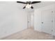 A bedroom with neutral carpet, white walls, ceiling fan, and a closet door is displayed at 211 E Rice St, Landis, NC 28088