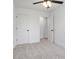 This bedroom features neutral carpet, a ceiling fan with lights, and a doorway leading to another room at 211 E Rice St, Landis, NC 28088