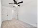 Bedroom with neutral carpet, white walls, ceiling fan, closet and entry doors at 211 E Rice St, Landis, NC 28088