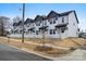 Charming townhouse row with white picket fences and well-manicured lawns, offering a blend of comfort and curb appeal at 211 E Rice St, Landis, NC 28088