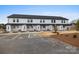 Townhouse exterior showcases white siding, dark trim, and dedicated parking, blending style with practical urban living at 211 E Rice St, Landis, NC 28088