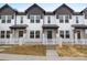 Charming townhome exterior with white siding, black trim, and a cozy fenced front yard at 211 E Rice St, Landis, NC 28088