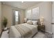 Cozy bedroom with a neutral color palette, soft textures, and natural light, creating a comfortable and relaxing space at 2110 Old Rivers Rd, Concord, NC 28027