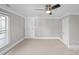 Bedroom featuring a ceiling fan, trim accents, and a large window for natural lighting at 220 W Bell St, Statesville, NC 28677