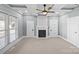 Spacious bedroom featuring carpet floors, a ceiling fan, a fireplace, and multiple doors at 220 W Bell St, Statesville, NC 28677