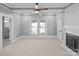 Spacious bedroom featuring carpet floors, a ceiling fan, fireplace, and ensuite bath access at 220 W Bell St, Statesville, NC 28677