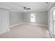 Bedroom featuring a ceiling fan, trim accents, and a large window for natural lighting at 220 W Bell St, Statesville, NC 28677