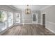 Dining room featuring wood flooring, modern lighting, and large windows at 220 W Bell St, Statesville, NC 28677