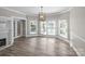 Open dining room featuring wood floors, bay windows, and modern lighting at 220 W Bell St, Statesville, NC 28677